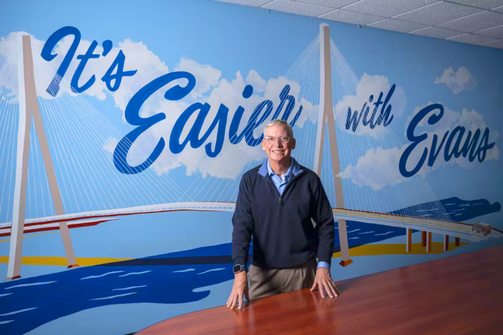 John Evans, President & CEO pictured at the Melvindale HQ facility in front of the a Gordie Howe Bridge mural.